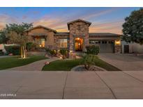 Beautiful front exterior of home features stone accents, manicured landscaping, and a welcoming entrance with a well-lit walkway at 3907 E Carob Dr, Gilbert, AZ 85298