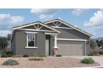 Charming single-story home with a two-car garage, desert landscaping and stone column at 47705 W Kenner Dr, Maricopa, AZ 85139