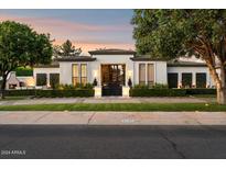 Stunning home featuring manicured landscaping, black framed windows, and an ornate black front gate at 5700 E Sanna St, Paradise Valley, AZ 85253