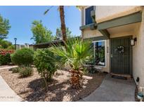 Charming front entrance with desert landscaping and a secure, decorative gate at 9047 N 52Nd Ave, Glendale, AZ 85302