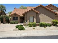 Charming single-story home with a clay tile roof, desert landscaping, and welcoming curb appeal at 9280 E Davenport Dr, Scottsdale, AZ 85260