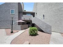 Charming condo exterior with a private patio, walkway, and desert landscaping at , Mesa, AZ 85201