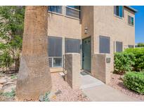 Inviting home entrance featuring a charming, well-lit doorway and desert landscaping at 101 N 7Th St # 168, Phoenix, AZ 85034