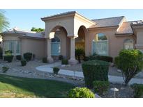 Charming single-story home features an arched entryway, tiled roof, desert landscaping, and lush green grass at 11290 N 117Th St, Scottsdale, AZ 85259