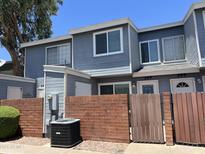 Two-story gray townhome with a brick privacy wall and well-maintained landscaping at 2301 E University Dr # 269, Mesa, AZ 85213