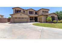 Stunning two-story home features a three car garage, stone accents, and mature landscaping at 3177 S Sierra St, Gilbert, AZ 85295