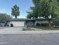 Charming single-story home with a well-maintained lawn and a two-car garage at 3639 W Beryl Ave, Phoenix, AZ 85051