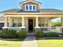 Charming single-Gathering home featuring a covered porch and landscaped front yard in a well-maintained community at 3765 N Denny Way, Buckeye, AZ 85396