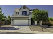 Charming two-story home featuring a large two-car garage and a beautifully landscaped front yard with mature trees at 41581 W Somerset Dr, Maricopa, AZ 85138