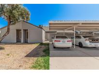 Carport featuring a paved driveway, parking for two cars, and a well-maintained home exterior at 4406 E Carter Dr, Phoenix, AZ 85042