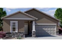 Inviting single-story home showcasing a two-car garage and neutral stucco facade accented by decorative stone trim at 5722 E Iris Dr, Florence, AZ 85132