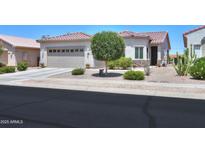 Charming single-story home with tile roof, desert landscaping, and a two-car garage at 60 S Agua Fria Ln, Casa Grande, AZ 85194