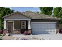 Charming single-story home featuring a stone-accented facade, a two-car garage, and a well-maintained lawn at 6050 E Artemis Dr, Florence, AZ 85132