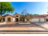 Charming single-story home featuring a three-car garage, well-maintained yard with mature trees, and a red tile roof at 882 N Concord Ave, Chandler, AZ 85225