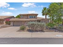 Charming two-story home with a well-manicured lawn, desert landscaping and attached garage at 14609 S 24Th Way, Phoenix, AZ 85048