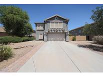 Charming two-story home featuring a well-manicured front yard and inviting curb appeal at 14770 W Columbine Dr, Surprise, AZ 85379