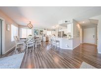 Open-concept dining and kitchen area with stylish flooring and abundant natural light at 14770 W Columbine Dr, Surprise, AZ 85379