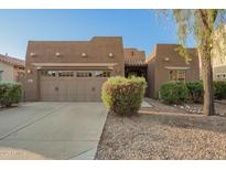 Charming single-story home featuring a well-manicured front yard and a two-car garage at 15674 W Mackenzie Dr, Goodyear, AZ 85395