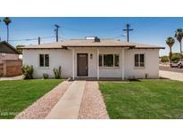 Charming single-story home with a well-manicured lawn and inviting front entrance at 162 N Hunt W Dr, Mesa, AZ 85203