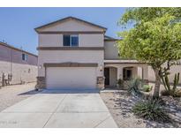 Charming two-story home featuring an attached two-car garage and landscaped front yard at 1671 E Silktassel Trl, San Tan Valley, AZ 85143