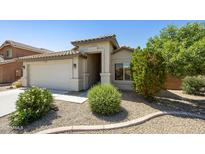 Charming single-story home showcasing desert landscaping and a two-car garage at 2011 W Burgess Ln, Phoenix, AZ 85041