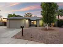 Charming single-story home with brick accents, a two-car garage, and desert landscaping at 2726 W Meseto Cir, Mesa, AZ 85202