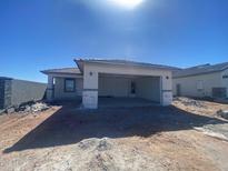 Single-story home featuring an attached two-car garage under a blue sky at 32002 N Pony Express Rd, San Tan Valley, AZ 85143