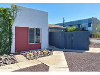 Charming home featuring unique architectural details, modern gray stucco, and a vibrant red accent wall at 3551 N 12Th St # 101, Phoenix, AZ 85014