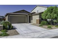 Charming single-story home with a spacious driveway and well-manicured landscaping enhancing its curb appeal at 36602 W San Alvarez Ave, Maricopa, AZ 85138