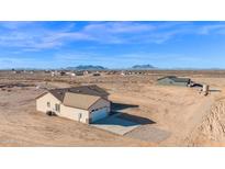 Spacious single-Gathering home featuring a two-car garage, neutral stucco and desert landscaping at 37504 W Elm Ave, Tonopah, AZ 85354