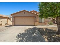Charming single-story home featuring a spacious two-car garage and a well-maintained front yard at 43938 W Colby Dr, Maricopa, AZ 85138