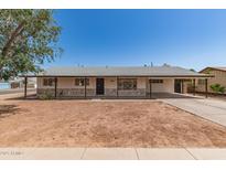 Charming single-story home featuring a covered carport, stone accents and low maintenance front yard at 501 W Dublin St, Chandler, AZ 85225