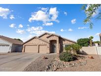 Charming single-story home with a three-car garage, desert landscaping, and a welcoming entrance at 635 S Lanus Dr, Gilbert, AZ 85296