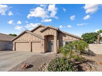 Attractive single-story home with a three-car garage, desert landscaping, and a neatly maintained yard at 635 S Lanus Dr, Gilbert, AZ 85296