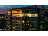 Modern condo building at twilight showcases a sleek design with expansive windows and balconies at 7180 E Kierland Blvd # 1116, Scottsdale, AZ 85254