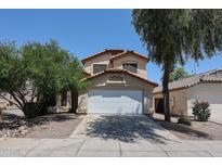 Two story home featuring a driveway, two car garage, desert landscaping, and a red tile roof at 12408 W Orange Dr, Litchfield Park, AZ 85340