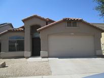 Charming single-story home with desert landscaping and a two-car garage at 12425 W Montebello Ave, Litchfield Park, AZ 85340