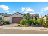 Charming single-story home featuring desert landscaping, a brick-paved driveway, and a two-car garage at 12672 W Marguerite Ave, Avondale, AZ 85323