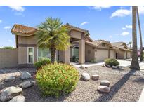 Charming home with a well-maintained front yard and a decorative desert landscape at 1449 W Sherri Dr, Gilbert, AZ 85233