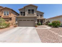 Charming two-story home featuring a two-car garage, desert landscaping, and a welcoming facade at 17560 W Young St, Surprise, AZ 85388