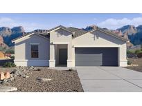 Charming single-story home featuring a two-car garage, neutral color palette, and a low-maintenance desert landscape at 2255 W Sheridan Ave, Apache Junction, AZ 85120