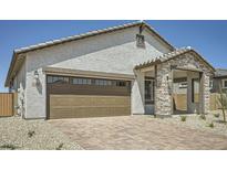 Charming single-Gathering home featuring stucco siding, brick accents, and a large two car garage at 25188 N 174Th Ave, Surprise, AZ 85387