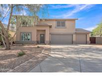 Two-story home featuring a spacious three car garage, desert landscaping, and neutral color palette at 308 E Sheffield Ct, Gilbert, AZ 85296