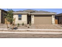 Charming single-story home featuring a two-car garage, desert landscaping, and a welcoming front entrance at 3129 S 155Th Ln, Goodyear, AZ 85338