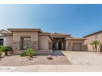 Charming single-story home with desert landscaping and a two-car garage at 371 W Indigo Dr, Chandler, AZ 85248