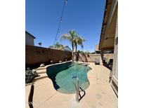Relaxing backyard pool area with desert landscaping and string lights for evening ambiance at 3891 E Simpson Rd, Gilbert, AZ 85297