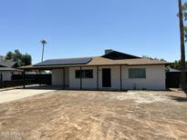 Charming single-story home featuring a covered carport, solar panels, and a freshly landscaped front yard at 4425 W Sierra St, Glendale, AZ 85304