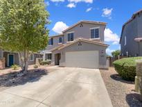 Beautiful two-story home featuring a two-car garage and well-maintained landscaping on a sunny day at 4990 E Odessa Dr, San Tan Valley, AZ 85140