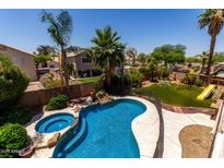 Inviting backyard pool and spa with mature landscaping and a fun playground for endless outdoor enjoyment at 735 W Kelton Ln, Phoenix, AZ 85023