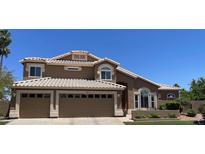 Charming two-story home with a two car garage and well-maintained landscaping, under a clear sky at 927 S Paradise Dr, Gilbert, AZ 85233